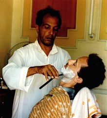 Dom having a cut throat shave at a Red Sea-front barber shop in Hurghada, Egypt. Photo taken by Maggie